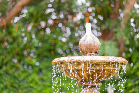 Round garden water fountain tiered in the park. selective focus.の写真素材