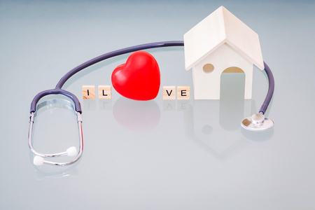 red heart using stethoscope for house health check. Concept of love and caring patient house by the heart. Copy space for the text and contentsの写真素材
