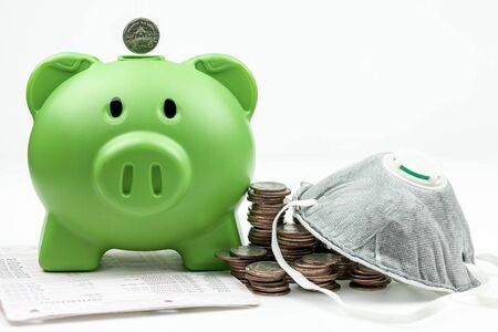 green piggy bank  of money box in the form of an agricultural animal with  coins isolated on a white...