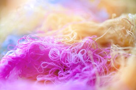 Multi-colored tangled threads abstract texture pattern background. Macro shot of colorful needlecraft silk thread ropes.の写真素材