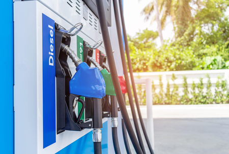A petrol pump gun in a petrol station. Close up on fuel nozzle in oil dispenser with gasoline and diesel in serviceのeditorial素材