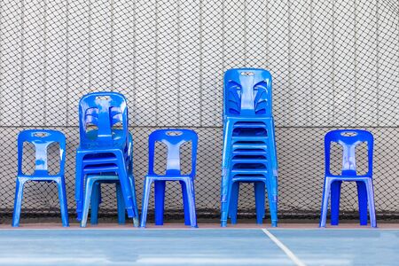 Many blue plastic chairs Stacked  , Used to Seat A Single Person for outdoor place.の写真素材