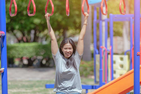 Portrait of beautiful young woman exercising in the park.の写真素材
