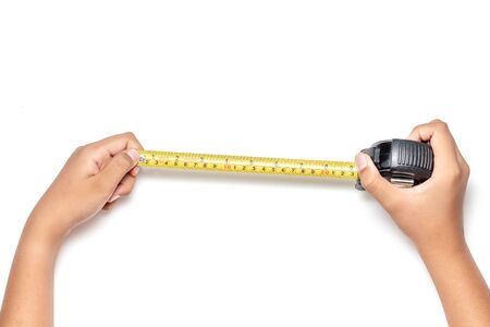 Close up view of man hand holding Tape measure. Human hands , isolated on white background measuring...