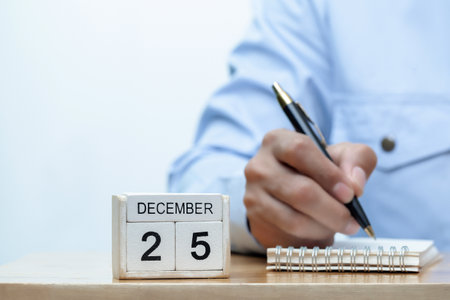 young  businessman hand hold a pen with deadline project concept and business stress conceptの写真素材