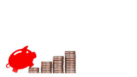 red piggy bank with coins . Concept of growth in savings.
