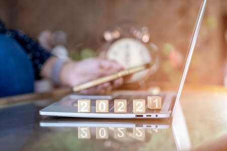 Abstract design concept - 2021, 2022 New year target plan with cubes of wooden blocks on notebook close up.selective focus.の写真素材