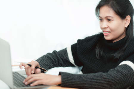 Shipping online, asian woman start up small business owner. The check list accepts the order online.  small business entrepreneur SME or freelance working at home.selective focus.の写真素材