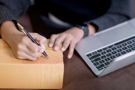 Shipping, online, asian, woman ,start up, small ,business ,owner,  order , business, entrepreneur, SME , freelance ,working, home,woman, reading, writing , digital, tablet, preparing, package, product, life style, concept, box, buying, computer, customer, deliver,delivery, document, ecommerce, happy, house, logistic, looking, people, post, sell, send, seller, service, shipment, store, website, successful, checking, contact, marketing, person, address, businesswoman, cardboard, communication, internet, professional, thai, home office, merchant, messenger;の写真素材