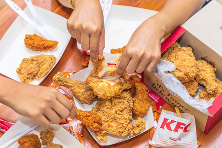 KFC is popular fast food chain known as Kentucky Fried Chicken.background of KFC restaurant.selective focus.THAILAND,29 Oct 2565のeditorial素材