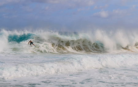 man surfing on the big wave at Sandy beach in Hawaiiの写真素材