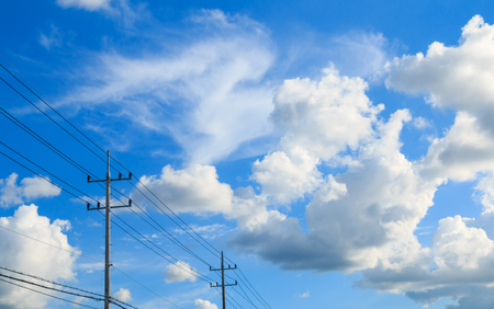 Blue sky and clouds with electric poles.の写真素材
