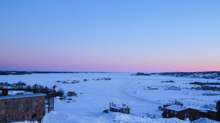 frozen lake covered with white snow at sunset in Yellowknife, Canadaの写真素材