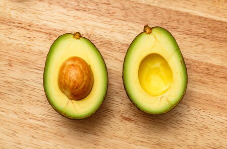 fresh avocados on wooden table.