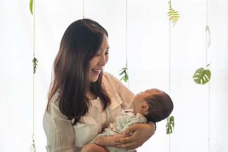 young mother holding her baby in the bosom