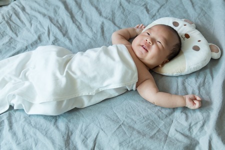 Asian baby lying on the bed