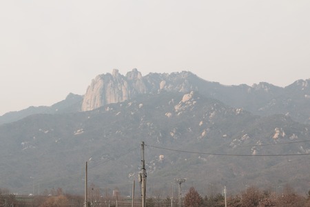 Mountain look blurred due to dense fine dust. Air pollution in Seoul, Koreaの写真素材