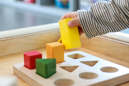 baby playing with colorful wooden blocksの写真素材