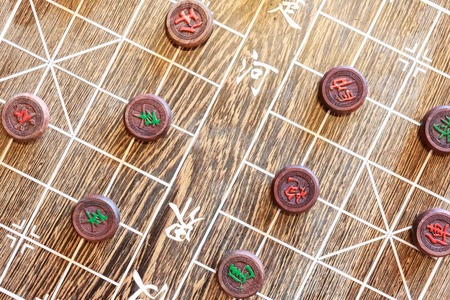 Wooden Chinese chess board and marker. The chinese character on marker indicates the branch of...
