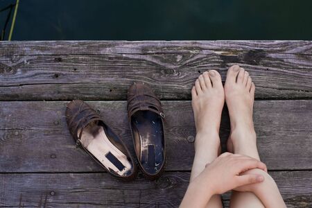 girl is relaxing at a lake on a afternoon in summerの写真素材