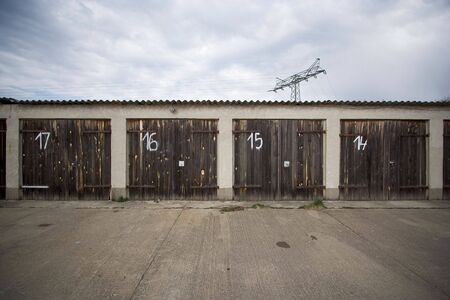 old storage spaces in front of a cloudy skyの写真素材