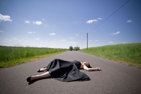 girl laying on the streetの写真素材