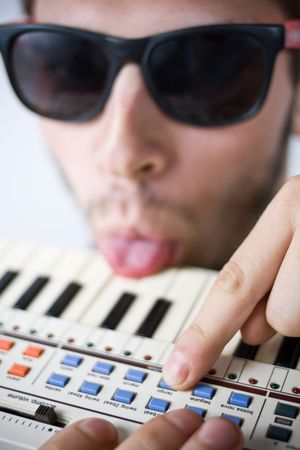 cool guy frustrated with his tiny keyboardの写真素材