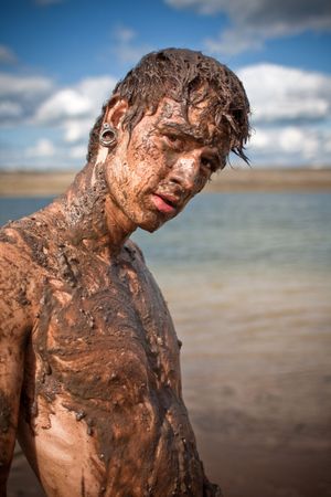 young guy full with mudの写真素材