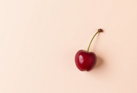 Red cherry on pastel background. Flat lay, top view.の素材