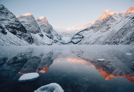 Beautiful winter landscape with frozen lake and mountains in the background.の素材