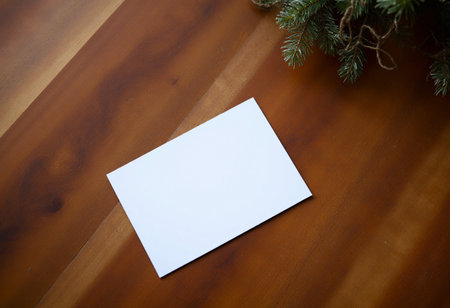 Blank business card on wooden background with christmas tree branch.の素材