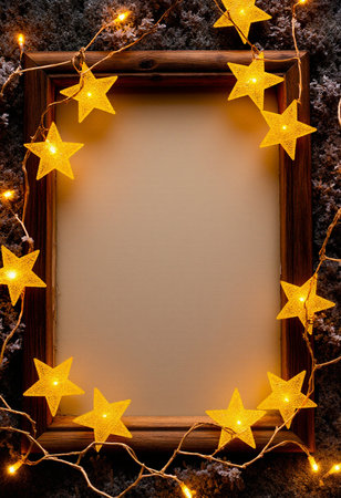 Wooden frame with christmas lights and stars on a stone backgroundの素材