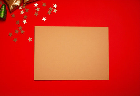 Christmas greeting card on red background. Flat lay, top view.の素材