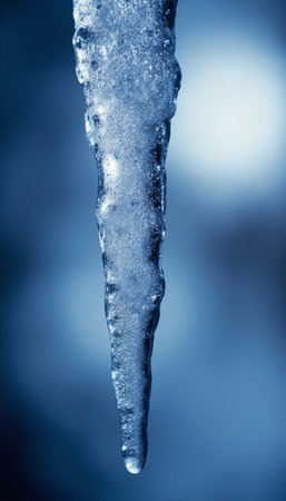 Icicles on a blue background. Close up. Toned.の素材