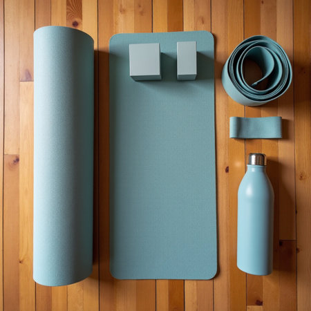 Top view of blue yoga mat and bottle with water on wooden backgroundの素材
