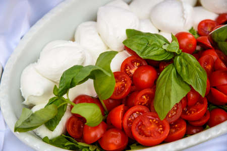 Mozzarella tomato and basil on a plate.の写真素材