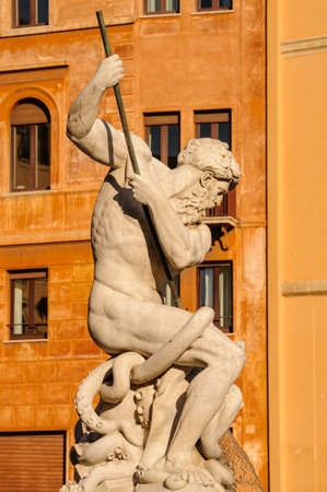 Details from a statue at the fountain of Neptune against an orange backdrop, Rome, Italy.の写真素材