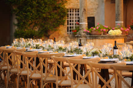 Outdoor summer wedding set up in a courtyard in Tuscany, Italy.の写真素材