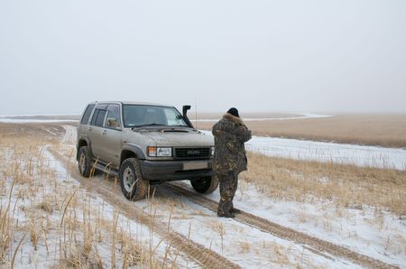 SUV on the bank against the backdrop of stormy sea. Off-road on Khasansky swamps in the border zone....