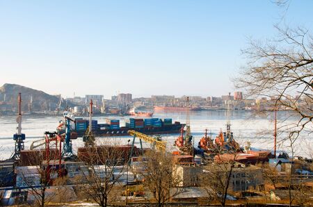 Port of Vladivostok. Container ship in the snowy haze.のeditorial素材