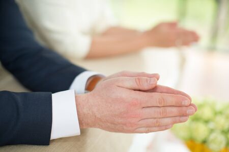 Close up hands of bride and groom. Image selective focus.