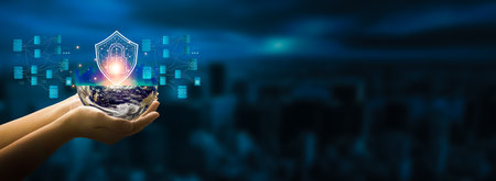 Businessman holding in hand Earth globe with shield on dark background.の写真素材