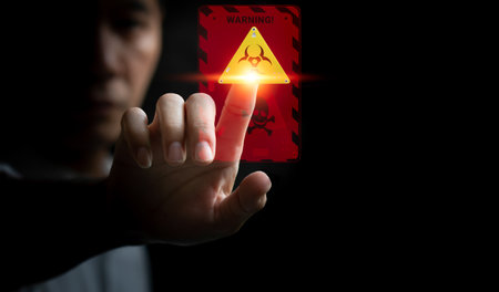 Close up of businessman touching icon of warning triangle sign on virtual screenの写真素材
