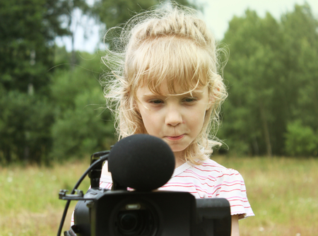 Cute little girl with camcorder isolated selfieの写真素材