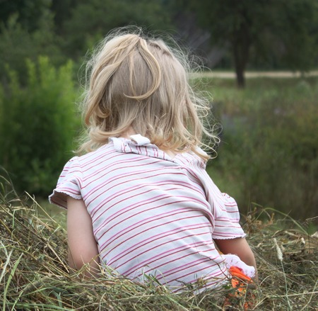 Adorable little girl laughing in a meadow - happy girlの写真素材