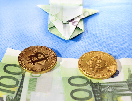 Blue background. European money, two bitkoy. A racing car made of money is 100 euros.の写真素材