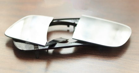 Wooden background. The car mirror is brokenの写真素材