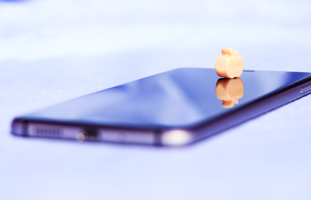 cellular telephone. An apple, a toy with an inscription. Close-up.の写真素材