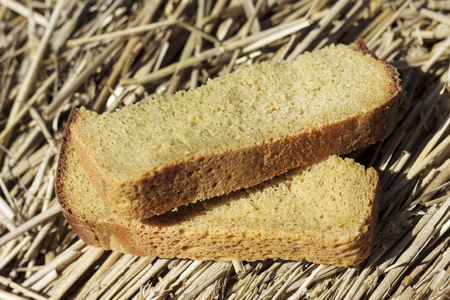 Two pieces of black bread. The bread lies on the grown bread. The depth of focus is very small.