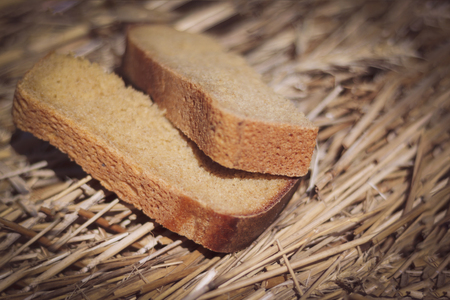 Two pieces of black bread. The bread lies on the grown bread. The depth of focus is very small
